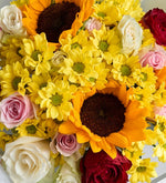 Girasol, rosa rosa y margarita amarilla en ramo gris