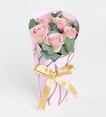 7 pink roses in a pink decorative box