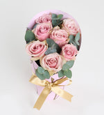 7 pink roses in a pink decorative box