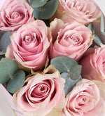 7 pink roses in a pink decorative box