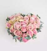 Pink rose with a yellow ribbon in a pink heart box