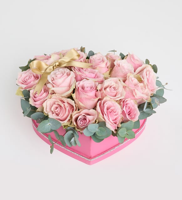 Pink rose with a yellow ribbon in a pink heart box
