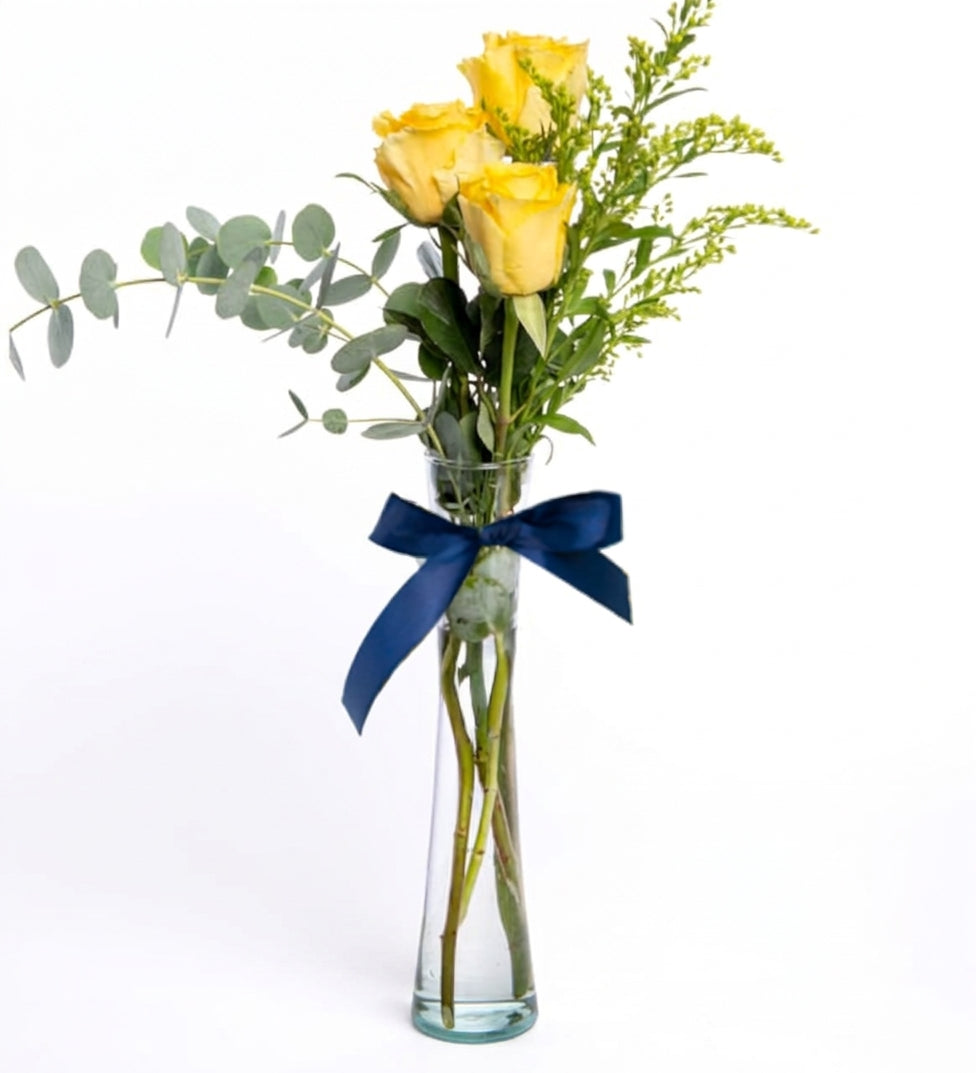 3 yellow roses in a cylindrical vase