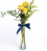 3 yellow roses in a cylindrical vase