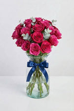 32 mini pink roses in glass vase