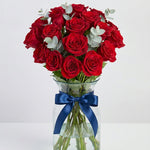 32 mini pink roses in glass vase