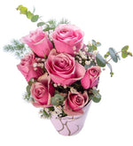 7 pink roses in a pink decorative box