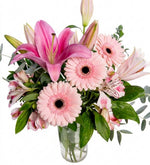 Alstroemerias, lilies, and white gerbera daisies in a vase