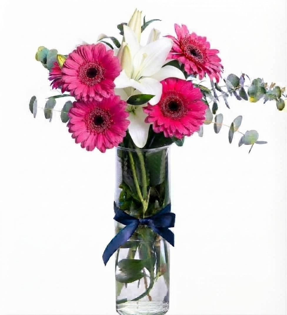 Colorful gerberas and white lilies in a vase