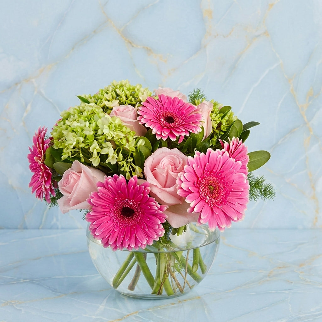 Gerberas and Roses in a fishbowl vase