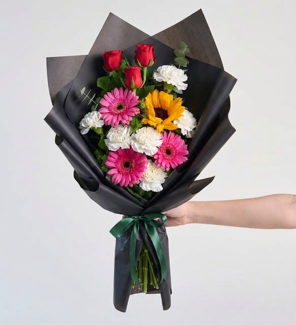 Bouquet of red rose, gerbera, and sunflower in silver